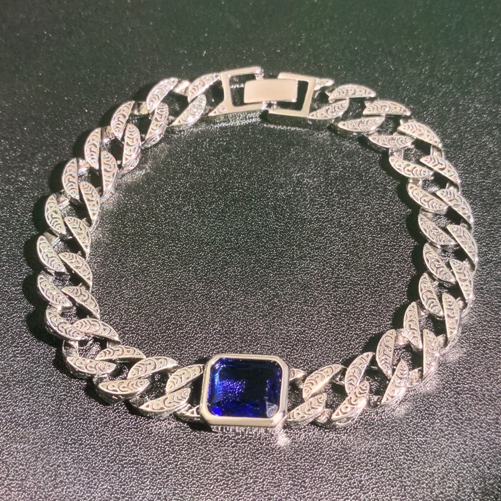 Intricate Silver Chain Bracelet with Deep Blue Stone
